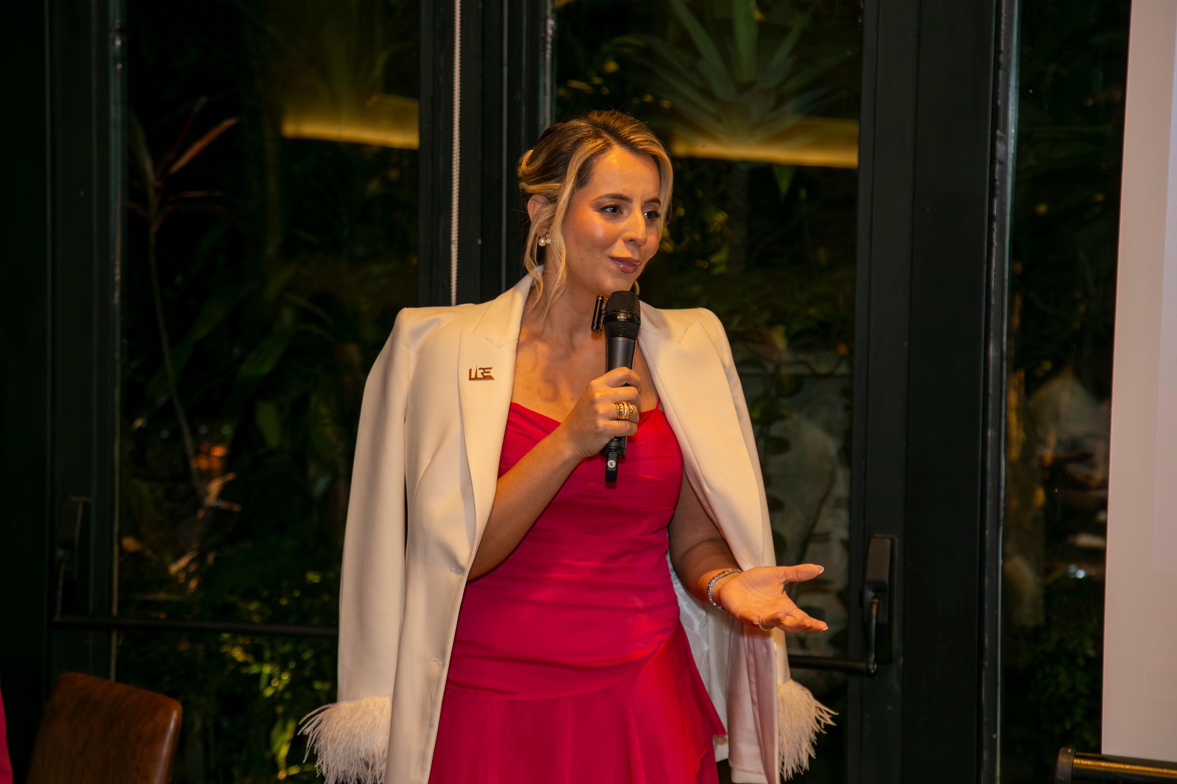 Sara Cristina speaking at a real estate event in Dubai